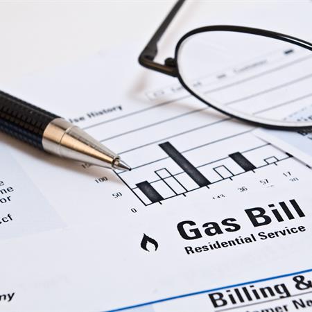 Natural gas paper bill with pen and glasses